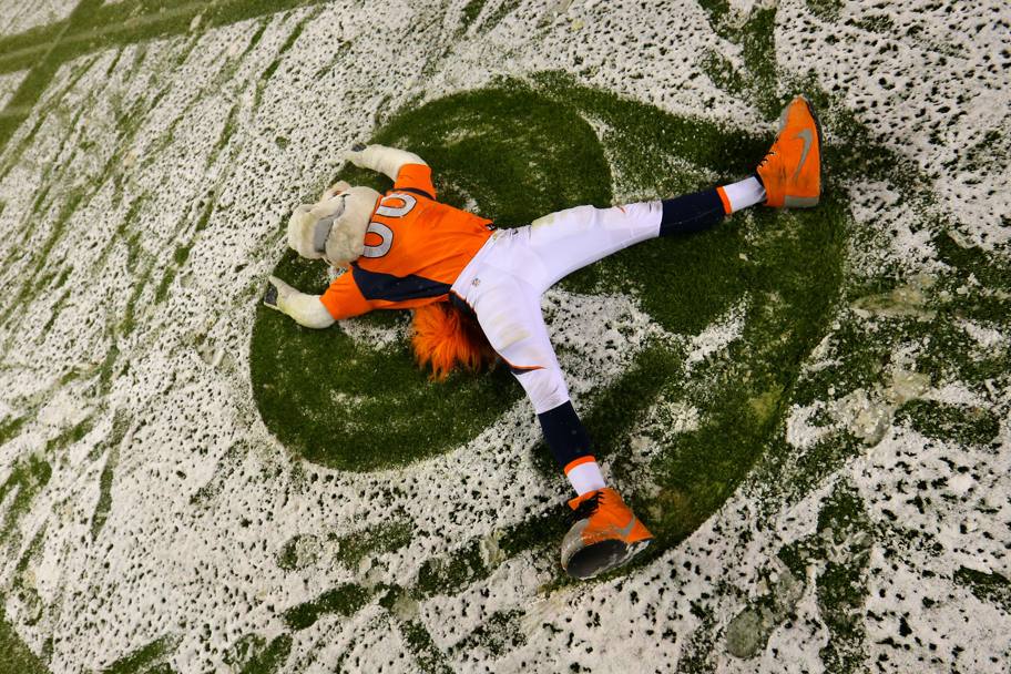 NFL, Denver, Colorado: la mascotte dei Denver Broncos festeggia la vittoria contro i New England rotolandosi sul campo da gioco coperto di neve. (Afp)